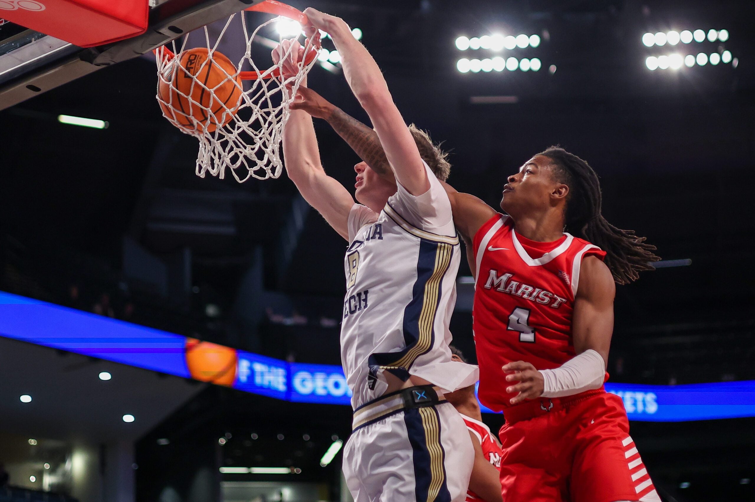 Dec 16, 2025; Atlanta, Georgia, USA; Georgia Tech Yellow Jackets center Cole Kirouac (8) dunks past Marist Red Foxes guard Rhyjon Blackwell (4) in the second half at McCamish Pavilion. Mandatory Credit: Brett Davis-Imagn Images
