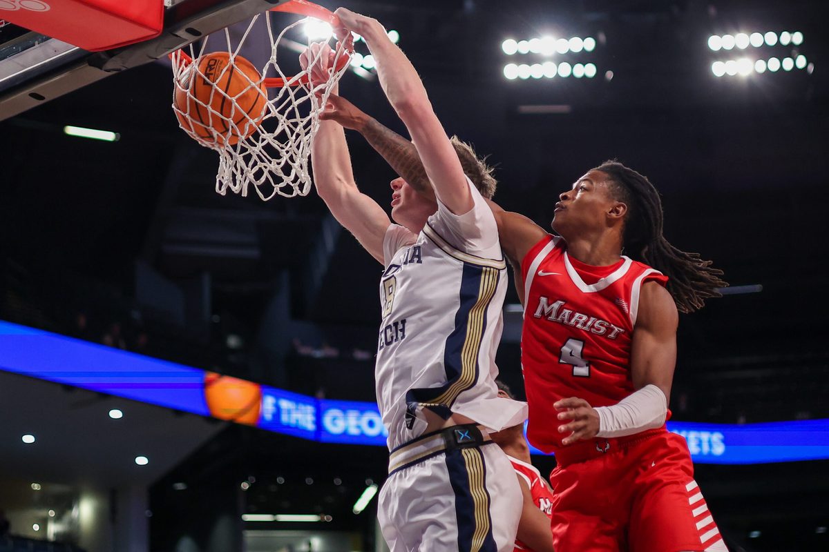 Dec 16, 2025; Atlanta, Georgia, USA; Georgia Tech Yellow Jackets center Cole Kirouac (8) dunks past Marist Red Foxes guard Rhyjon Blackwell (4) in the second half at McCamish Pavilion. Mandatory Credit: Brett Davis-Imagn Images
