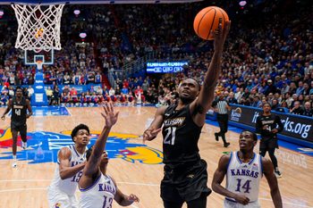 Dec 16, 2025; Lawrence, Kansas, USA; Towson Tigers guard Jack Doumbia Jr. (21) shoots against the Kansas Jayhawks during the first half at Allen Fieldhouse. Mandatory Credit: Jay Biggerstaff-Imagn Images