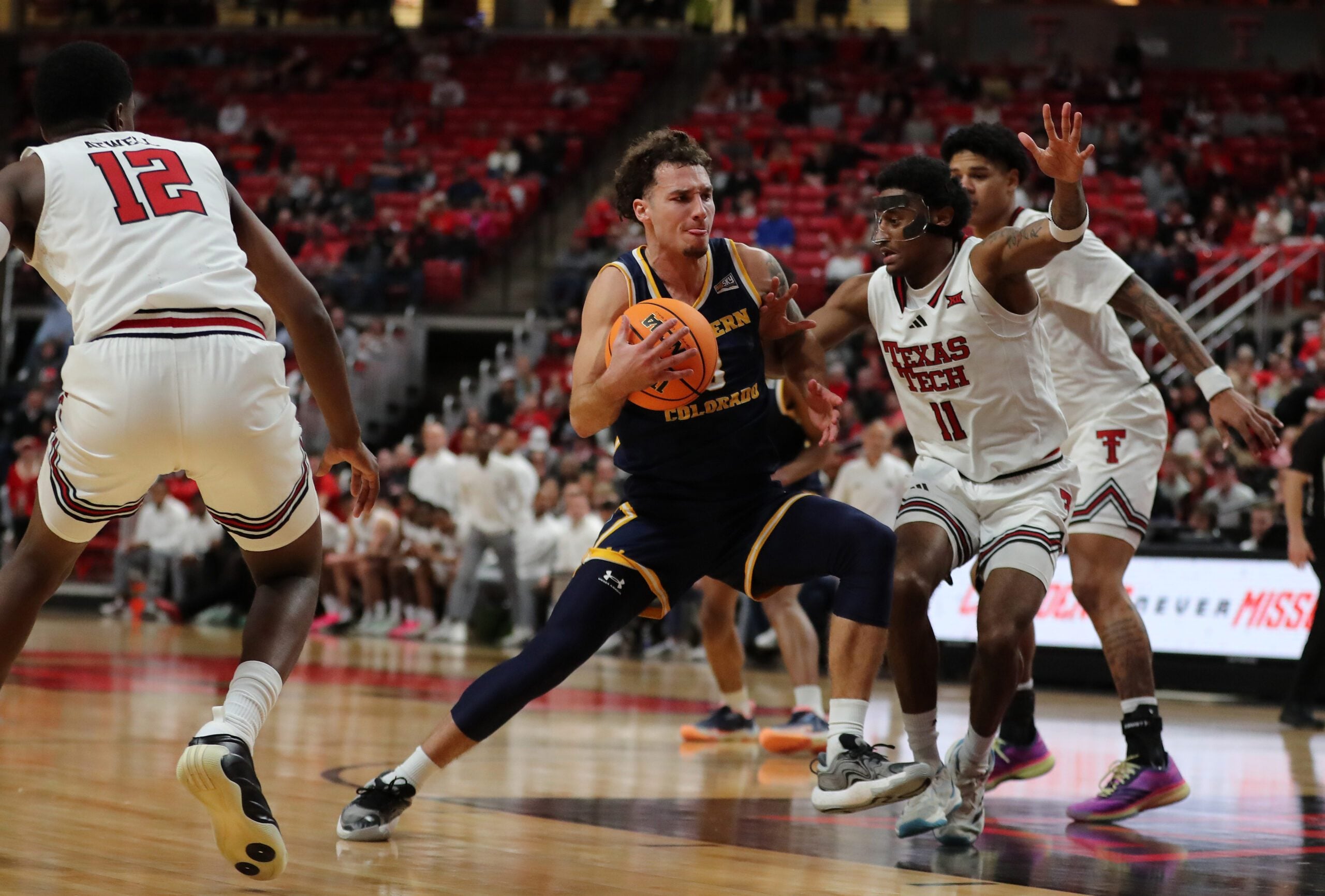 Dec 16, 2025; Lubbock, Texas, USA;  Northern Colorado Bears guard Zach Bloch (8) drives to the paint against Texas Tech Red Raiders guard Jaylen Petty (11) in the second half at United Supermarkets Arena. Mandatory Credit: Michael C. Johnson-Imagn Images