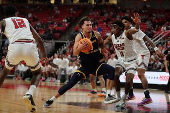 Dec 16, 2025; Lubbock, Texas, USA;  Northern Colorado Bears guard Zach Bloch (8) drives to the paint against Texas Tech Red Raiders guard Jaylen Petty (11) in the second half at United Supermarkets Arena. Mandatory Credit: Michael C. Johnson-Imagn Images