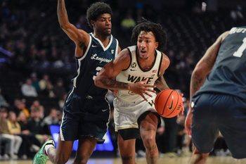 Dec 17, 2025; Winston-Salem, North Carolina, USA;  Wake Forest Demon Deacons guard Juke Harris (2) handles the ball defended by Longwood Lancers guard Alphonzo Billups III (3) during the first half at Lawrence Joel Veterans Memorial Coliseum. Mandatory Credit: Jim Dedmon-Imagn Images