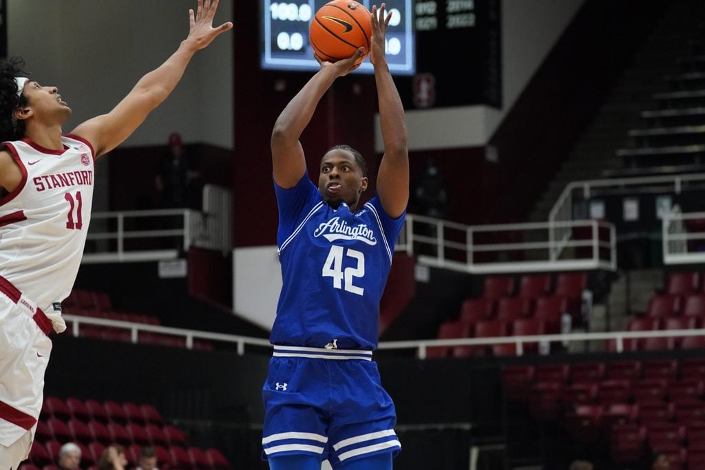 Dec 17, 2025; Stanford, California, USA; Texas-Arlington Mavericks guard Marcell McCreary (42) shoots over Stanford Cardinal guard Ryan Agarwal (11) in the first half at Maples Pavilion. Mandatory Credit: David Gonzales-Imagn Images