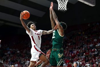 Dec 17, 2025; Tuscaloosa, Alabama, USA; Alabama Crimson Tide guard Labaron Philon (0) drives against South Florida Bulls forward Izaiyah Nelson (35) during the second half at Coleman Coliseum. Mandatory Credit: David Leong-Imagn Images