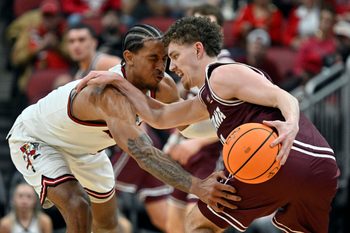 Dec 20, 2025; Louisville, Kentucky, USA;  Montana Grizzlies guard Grant Kepley (11) dribbles under the pressure of Louisville Cardinals forward Khani Rooths (9) during the second half at KFC Yum! Center. Louisville defeated Montana 94-54. Mandatory Credit: Jamie Rhodes-Imagn Images