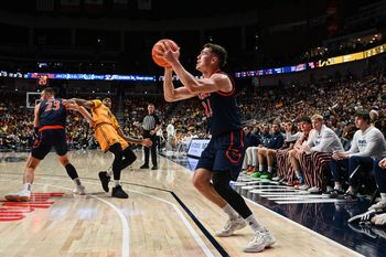 Dec 20, 2025; Iowa City, Iowa, USA; Bucknell Bison guard Achile Spadone (24) shoots a three-point basket against the Iowa Hawkeyes during the second half at Casey’s Center. Mandatory Credit: Jeffrey Becker-Imagn Images