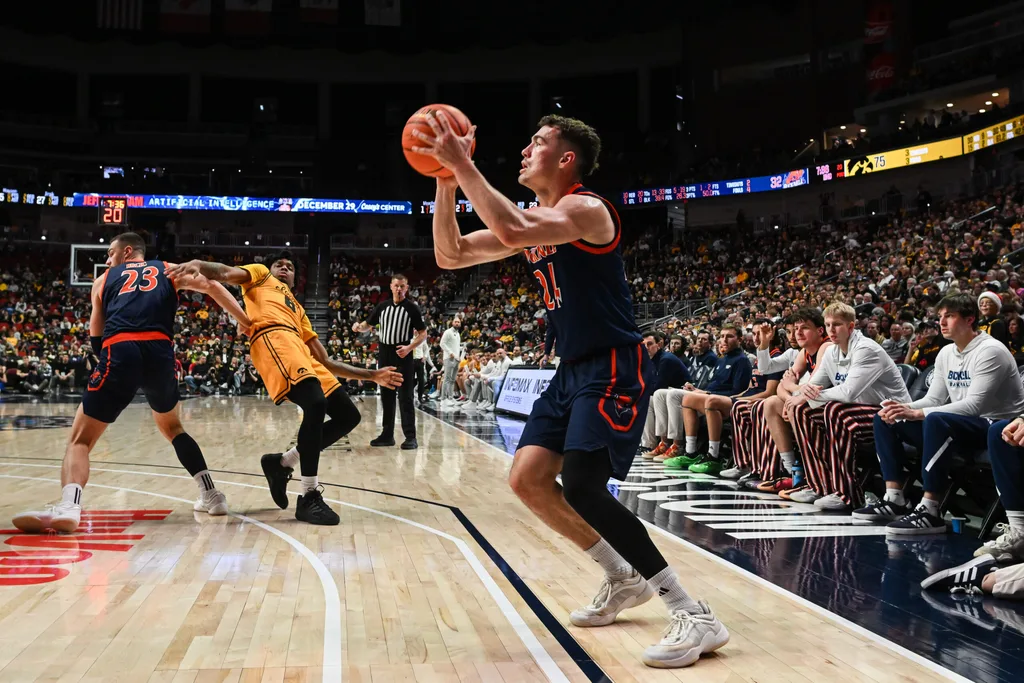 Dec 20, 2025; Iowa City, Iowa, USA; Bucknell Bison guard Achile Spadone (24) shoots a three-point basket against the Iowa Hawkeyes during the second half at Casey’s Center. Mandatory Credit: Jeffrey Becker-Imagn Images