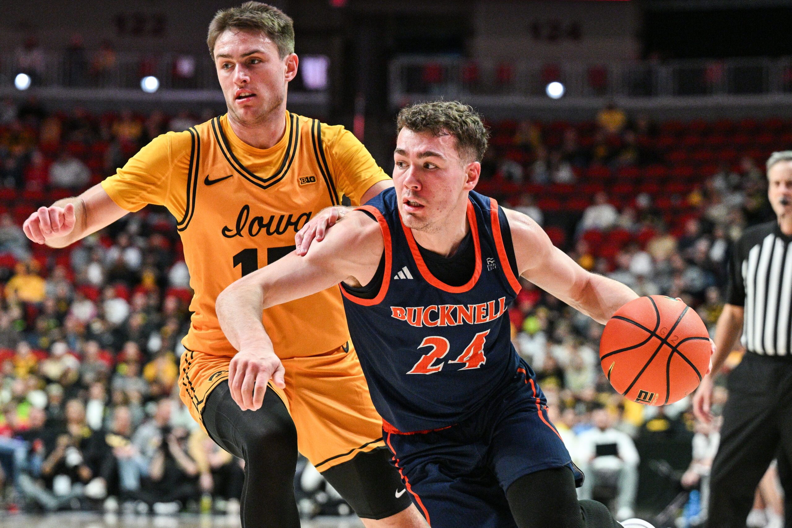 Dec 20, 2025; Iowa City, Iowa, USA; Bucknell Bison guard Achile Spadone (24) controls the ball as Iowa Hawkeyes guard Brendan Hausen (15) defends during the second half at Casey’s Center. Mandatory Credit: Jeffrey Becker-Imagn Images