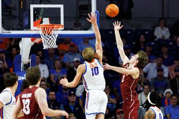 Dec 21, 2025; Gainesville, Florida, USA; Colgate Raiders forward Ethan Brown (0) shoots over Florida Gators forward Thomas Haugh (10) during the second half at Exactech Arena at the Stephen C. O'Connell Center. Mandatory Credit: Matt Pendleton-Imagn Images