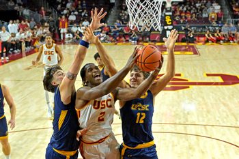 Dec 21, 2025; Los Angeles, California, USA; USC Trojans forward Ezra Ausar (2) is defended by UC Santa Cruz Banana Slugs center Joseph Espy (55) and guard Thomas Conley (12) as he drives to the basket in the first half at Galen Center. Mandatory Credit: Jayne Kamin-Oncea-Imagn Images