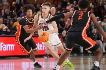 ASU Sun Devils guard Noah Meeusen (15) drives past Oregon State Beavers guard Dez White (0) at Desert Financial Arena in Tempe on Dec. 21, 2025.