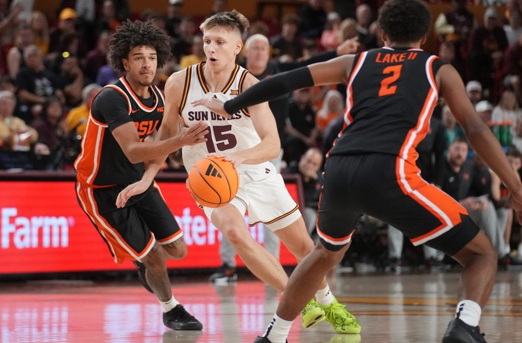 ASU Sun Devils guard Noah Meeusen (15) drives past Oregon State Beavers guard Dez White (0) at Desert Financial Arena in Tempe on Dec. 21, 2025.