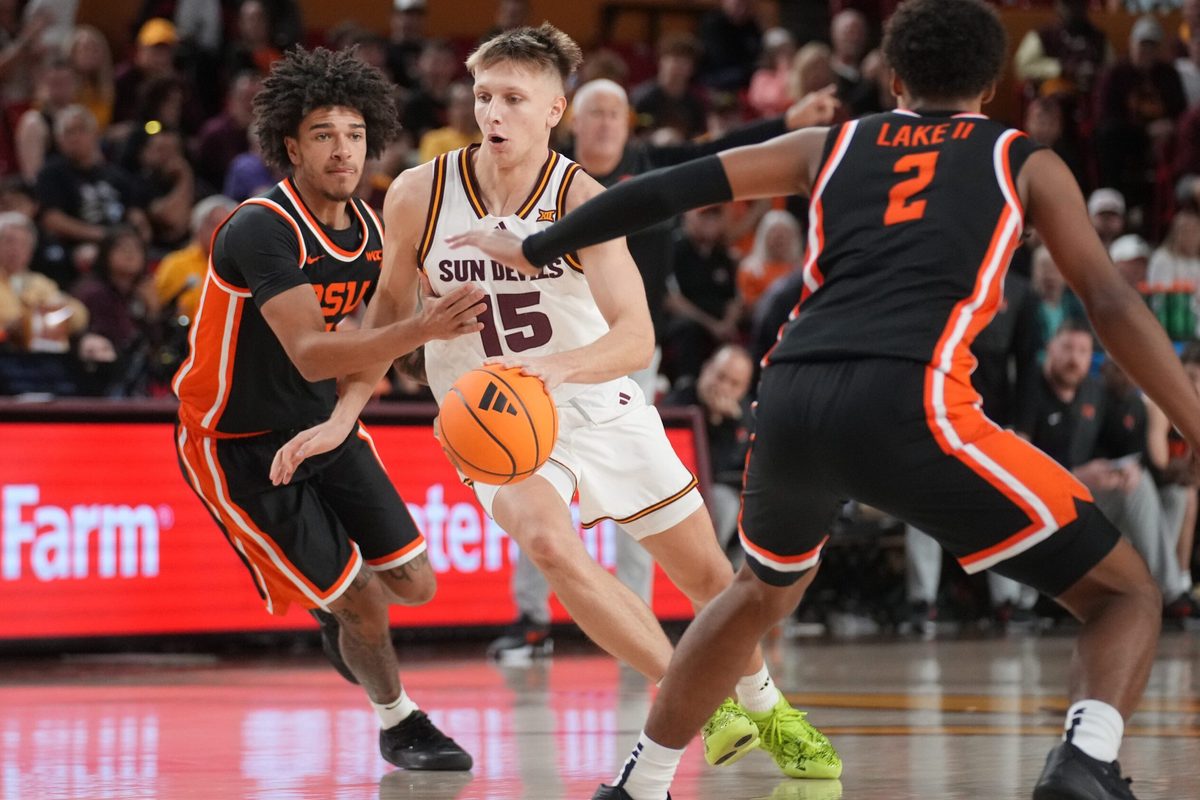 ASU Sun Devils guard Noah Meeusen (15) drives past Oregon State Beavers guard Dez White (0) at Desert Financial Arena in Tempe on Dec. 21, 2025.