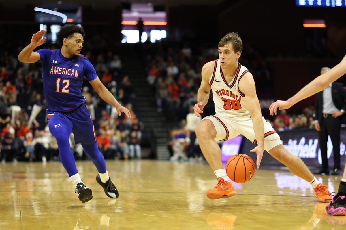 Dec 22, 2025; Charlottesville, Virginia, USA; Virginia Cavaliers guard Dallin Hall (30) drives to the basket as American University Eagles guard Geoff Sprouse (12) defends in the second half at John Paul Jones Arena. Mandatory Credit: Geoff Burke-Imagn Images