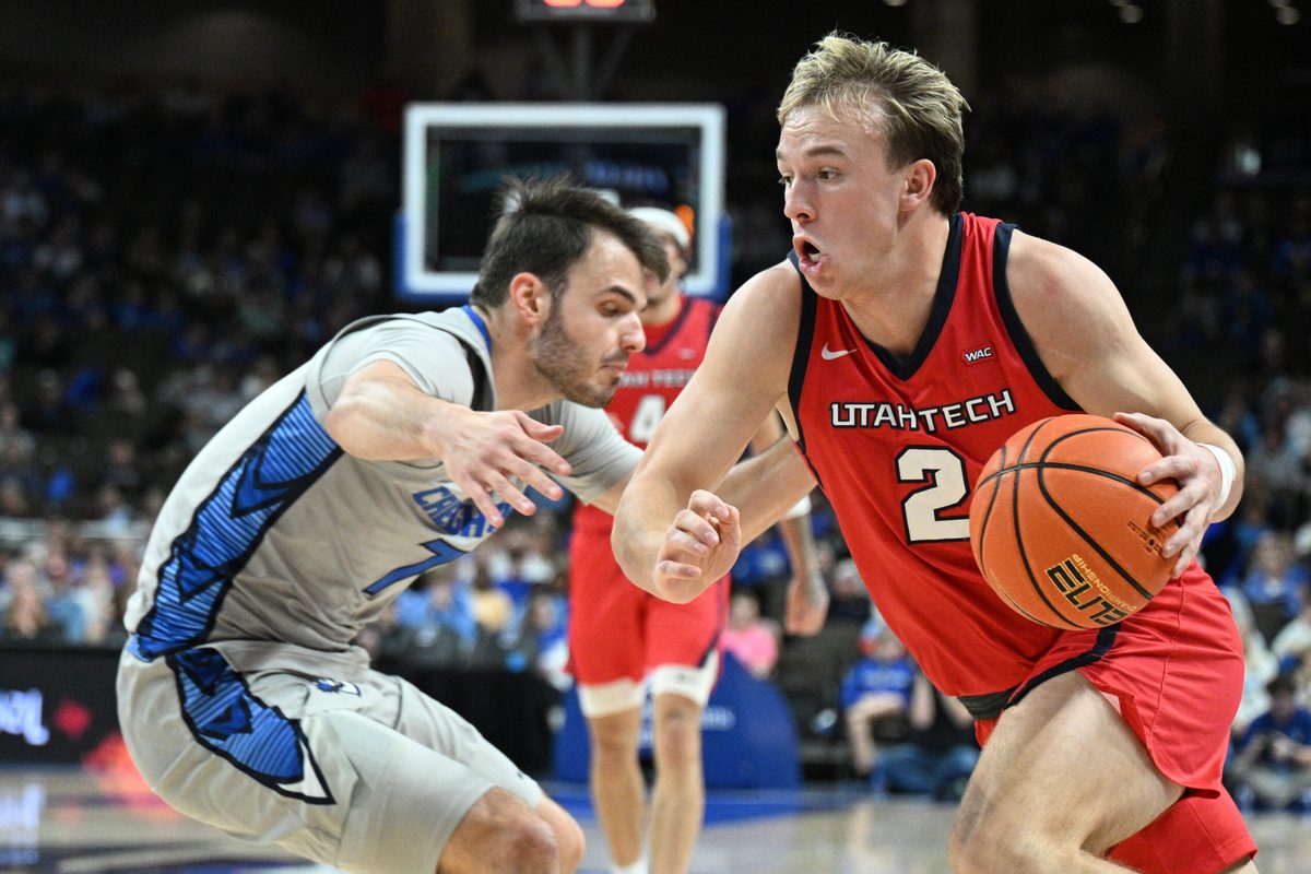 Dec 22, 2025; Omaha, Nebraska, USA; Utah Tech Trailblazers guard Chance Trujillo (2) drives around Creighton Bluejays guard Fedor Zugic (7) during the first half at CHI Health Center Omaha. Mandatory Credit: Steven Branscombe-Imagn Images