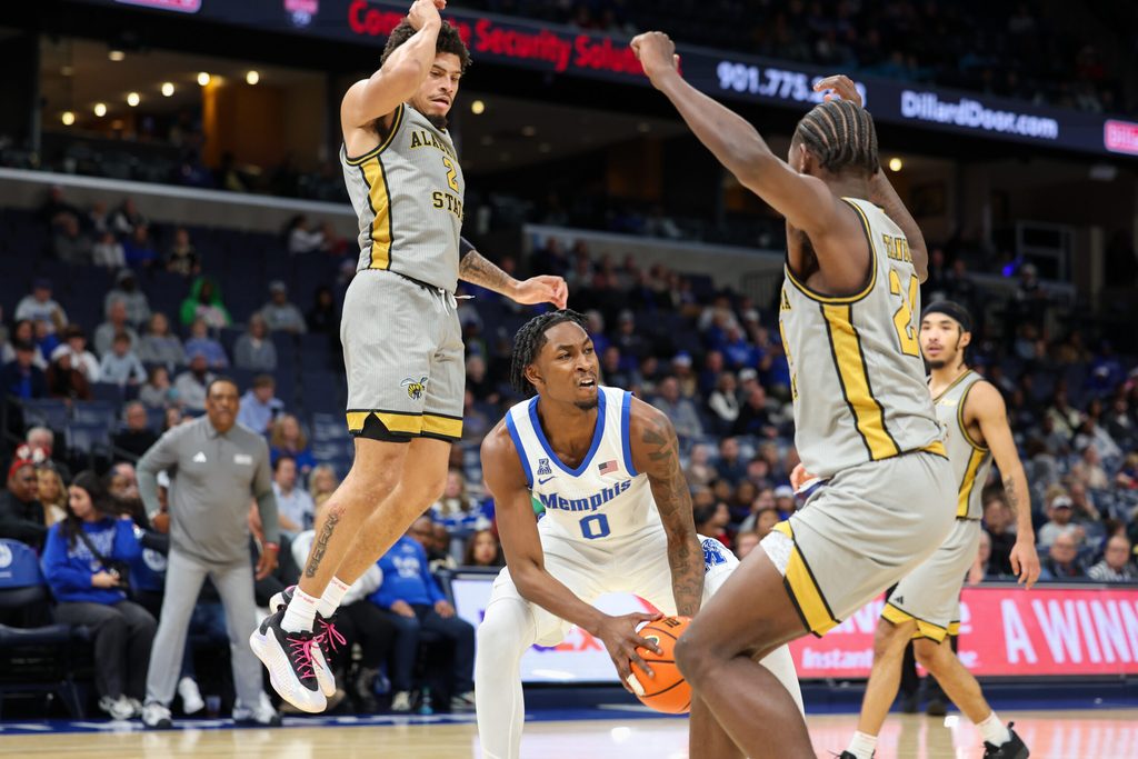 Dec 22, 2025; Memphis, Tennessee, USA; Memphis Tigers guard Quante Berry (0) handles the ball against Alabama State Hornets guard Micah Simpson (2) and forward Jerquarius Stanback (24) during the first half at FedExForum. Mandatory Credit: Wesley Hale-Imagn Images