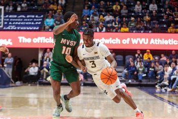 Dec 22, 2025; Morgantown, West Virginia, USA; West Virginia Mountaineers guard Honor Huff (3) drives against Mississippi Valley State Delta Devils guard Michael James (10) during the second half at Hope Coliseum. Mandatory Credit: Ben Queen-Imagn Images