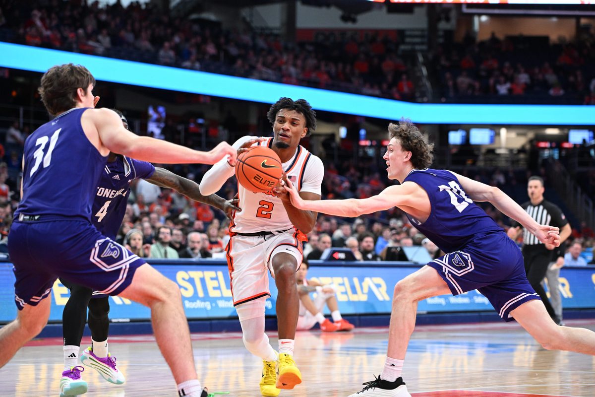 Dec 22, 2025; Syracuse, New York, USA; Syracuse Orange guard J.J. Starling (2) drives to the basket between Stonehill Skyhawks forward Cory Lovell (20) and forward Pearse McGuinn (31) in the second half at the JMA Wireless Dome. Mandatory Credit: Mark Konezny-Imagn Images