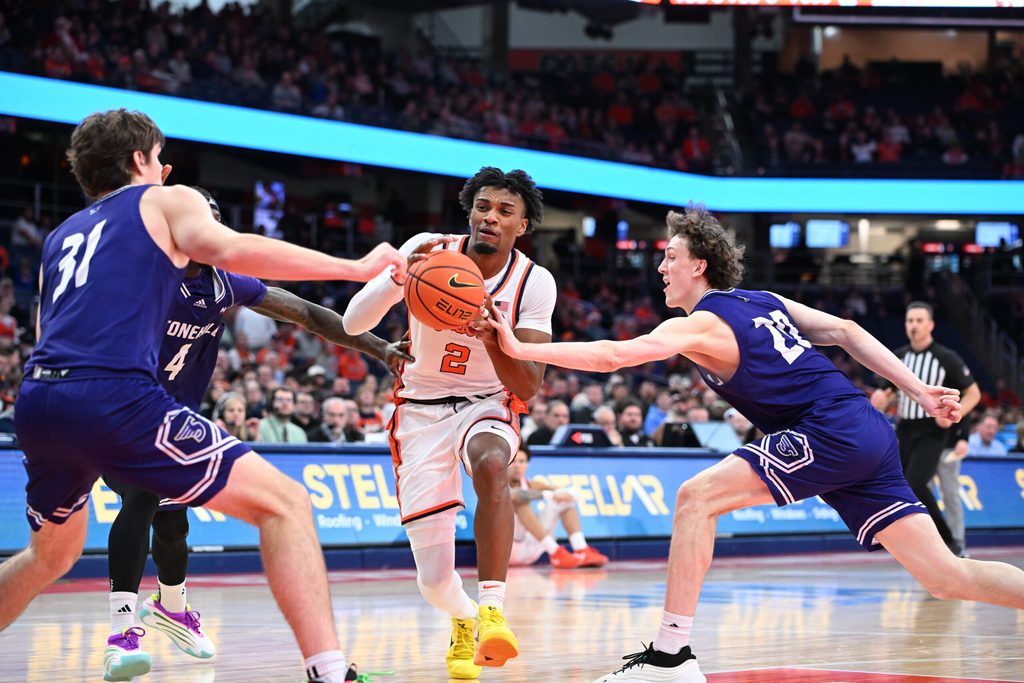 Dec 22, 2025; Syracuse, New York, USA; Syracuse Orange guard J.J. Starling (2) drives to the basket between Stonehill Skyhawks forward Cory Lovell (20) and forward Pearse McGuinn (31) in the second half at the JMA Wireless Dome. Mandatory Credit: Mark Konezny-Imagn Images