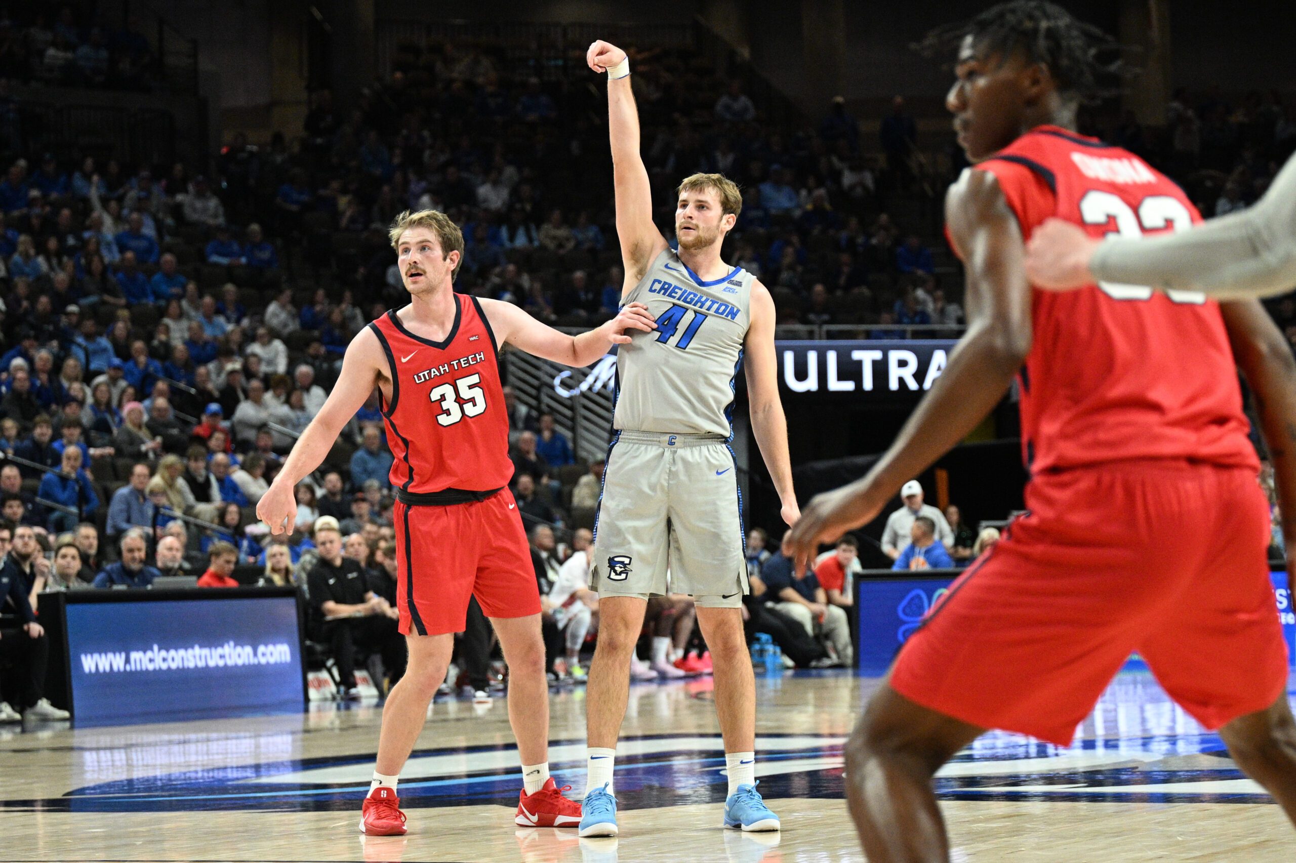 Dec 22, 2025; Omaha, Nebraska, USA;  Creighton Bluejays forward Isaac Traudt (41) watches a three point basket fall against Utah Tech Trailblazers forward Ethan Potter (35) during the second half at CHI Health Center Omaha. Mandatory Credit: Steven Branscombe-Imagn Images