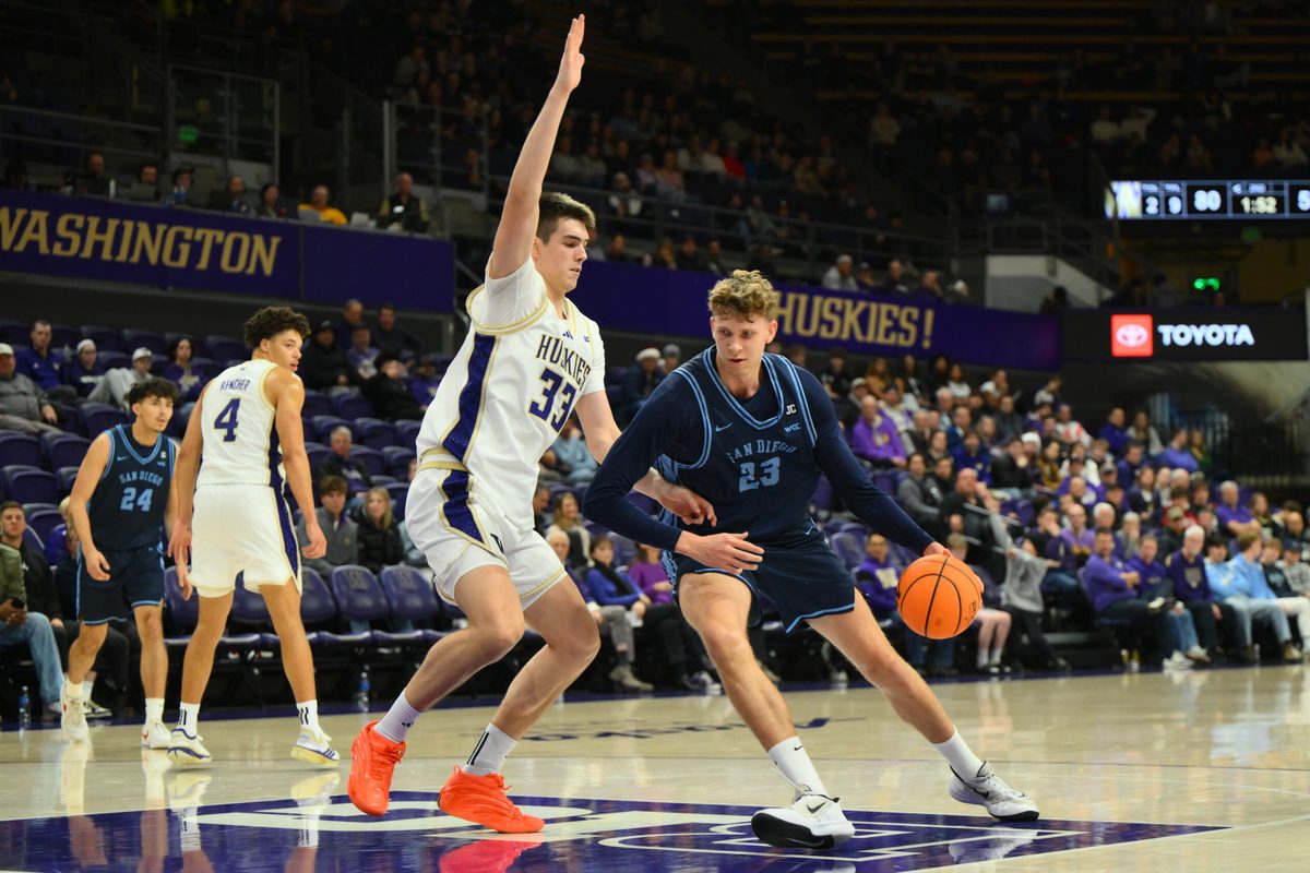 Dec 22, 2025; Seattle, Washington, USA; Washington Huskies forward Nikola Dzepina (33) defends San Diego Toreros center Piotr Winkowski (23) during the second half at Alaska Airlines Arena at Hec Edmundson Pavilion. Mandatory Credit: Steven Bisig-Imagn Images