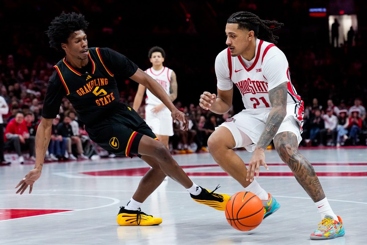 Ohio State Buckeyes forward Devin Royal (21) moves the ball past Grambling State Tigers Jimel Lane (5) in the second half of the NCAA men’s basketball game Value City Arena on Tuesday, Dec. 23, 2025 in Columbus, Ohio.