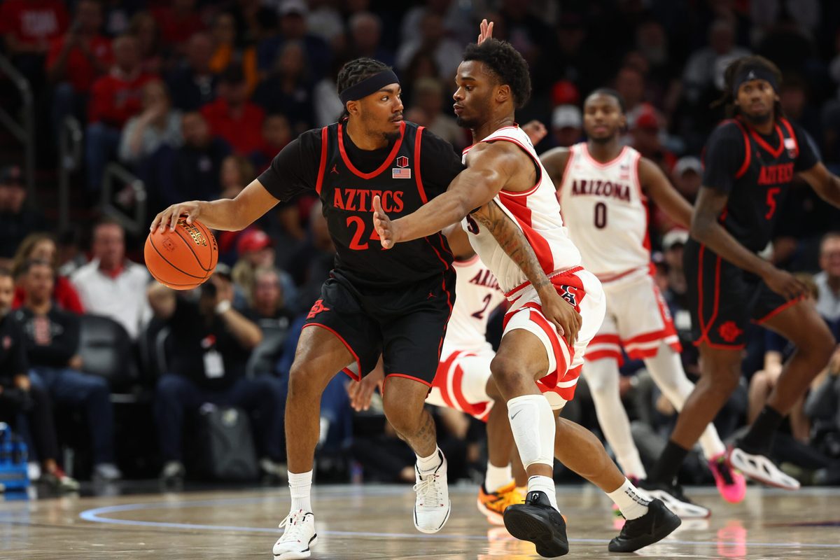 Dec 20, 2025; Phoenix, Arizona, USA; Arizona Wildcats forward Tobe Awaka (30) defends against San Diego State Aztecs guard Taj DeGourville (24) during the Hall of Fame Series at Mortgage Matchup Center. Mandatory Credit: Mark J. Rebilas-Imagn Images
