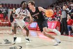 Dec 23, 2025; Queens, New York, USA;  Harvard Crimson guard Austin Hunt (7) drives past St. John's Red Storm guard Ian Jackson (11) in the first half at Carnesecca Arena. Mandatory Credit: Wendell Cruz-Imagn Images