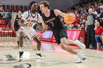 Dec 23, 2025; Queens, New York, USA;  Harvard Crimson guard Austin Hunt (7) drives past St. John's Red Storm guard Ian Jackson (11) in the first half at Carnesecca Arena. Mandatory Credit: Wendell Cruz-Imagn Images