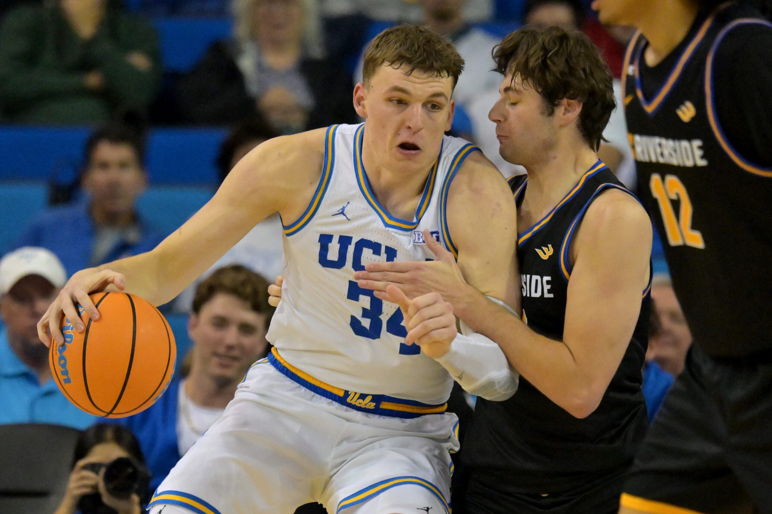 Dec 23, 2025; Los Angeles, California, USA; UCLA Bruins forward Tyler Bilodeau (34) is defended by UC Riverside Highlanders forward Dylan Godfrey (23) in the second half at Pauley Pavilion presented by Wescom Financial. Mandatory Credit: Jayne Kamin-Oncea-Imagn Images