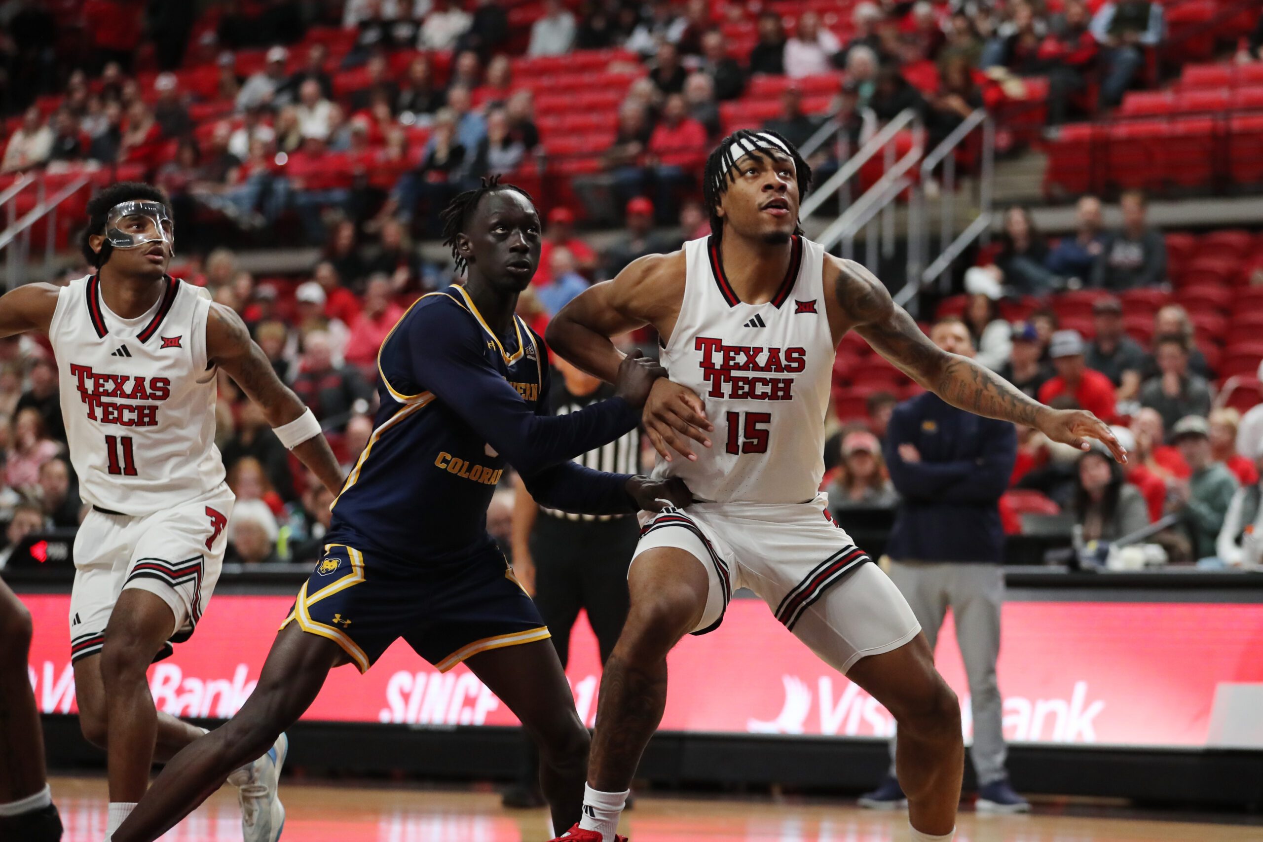 Dec 16, 2025; Lubbock, Texas, USA;  Texas Tech Red Raiders forward JT Toppin (15) blocks out Northern Colorado Bears guard Ariik Mawien (3) in the second half at United Supermarkets Arena. Mandatory Credit: Michael C. Johnson-Imagn Images