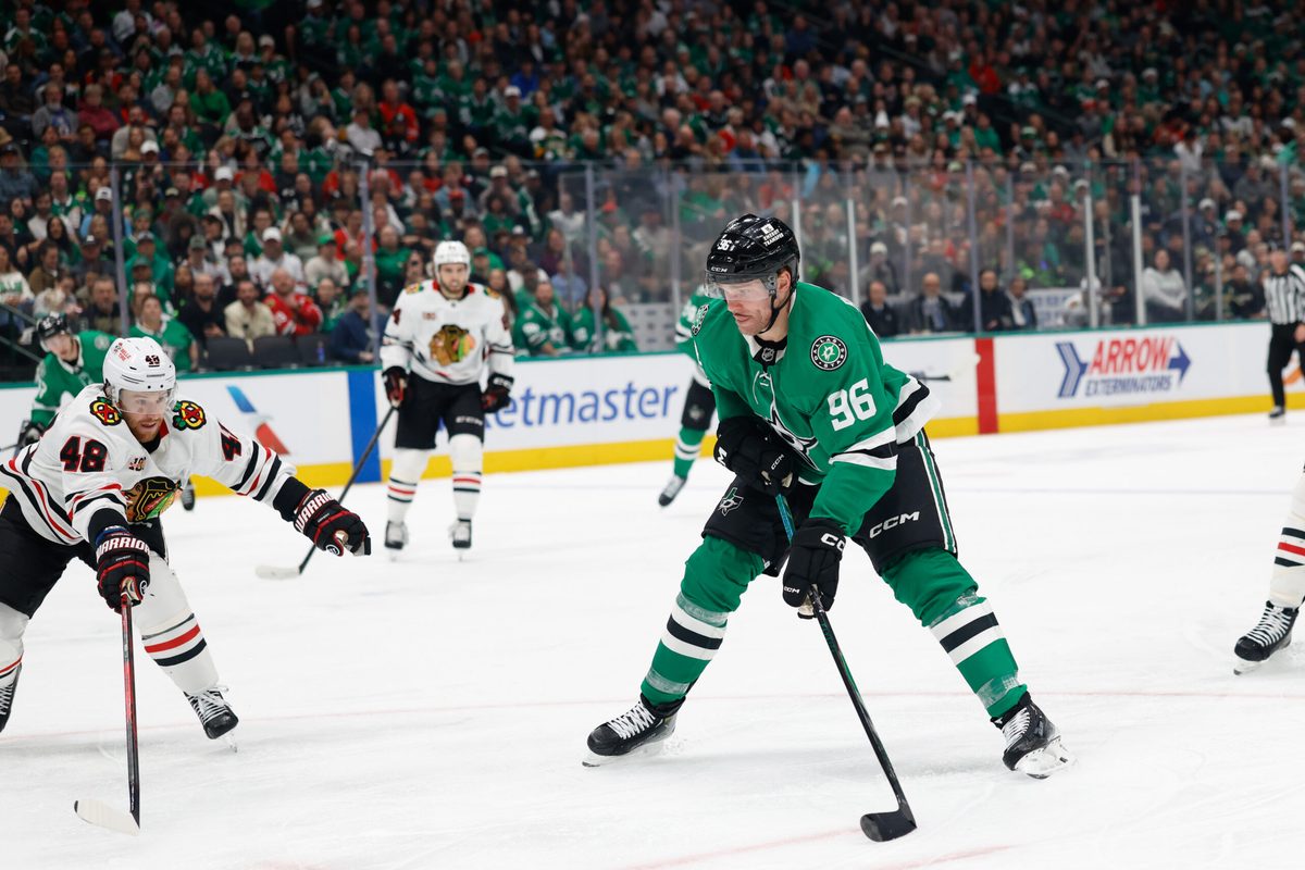 Dec 27, 2025; Dallas, Texas, USA;  Dallas Stars right wing Mikko Rantanen (96) shoots the puck against Chicago Blackhawks defenseman Matt Grzelcyk (48) during the second period at American Airlines Center. Mandatory Credit: Chris Jones-Imagn Images