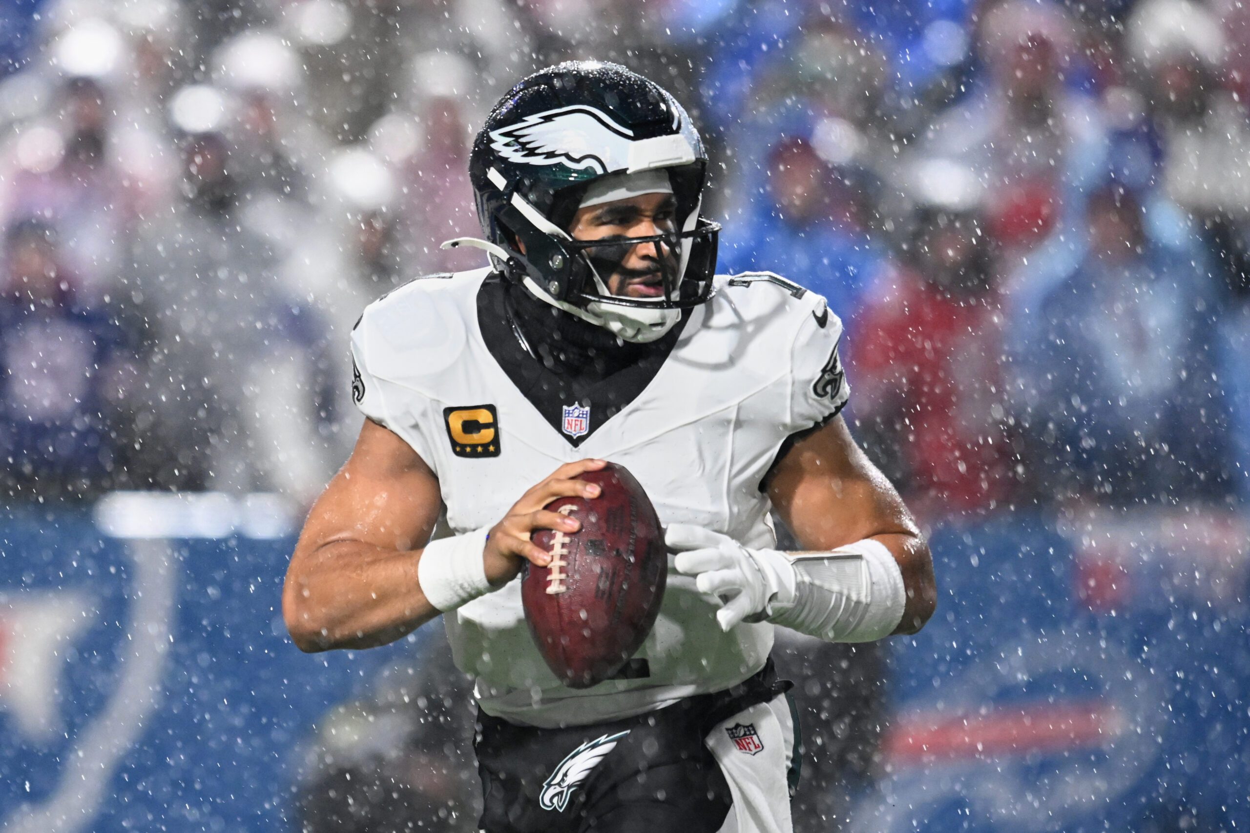 Dec 28, 2025; Orchard Park, New York, USA; Philadelphia Eagles quarterback Jalen Hurts (1) looks to throw a pass in heavy rain against the Buffalo Bills during the second quarter at Highmark Stadium. Mandatory Credit: Mark Konezny-Imagn Images
