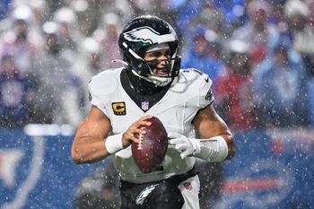 Dec 28, 2025; Orchard Park, New York, USA; Philadelphia Eagles quarterback Jalen Hurts (1) looks to throw a pass in heavy rain against the Buffalo Bills during the second quarter at Highmark Stadium. Mandatory Credit: Mark Konezny-Imagn Images
