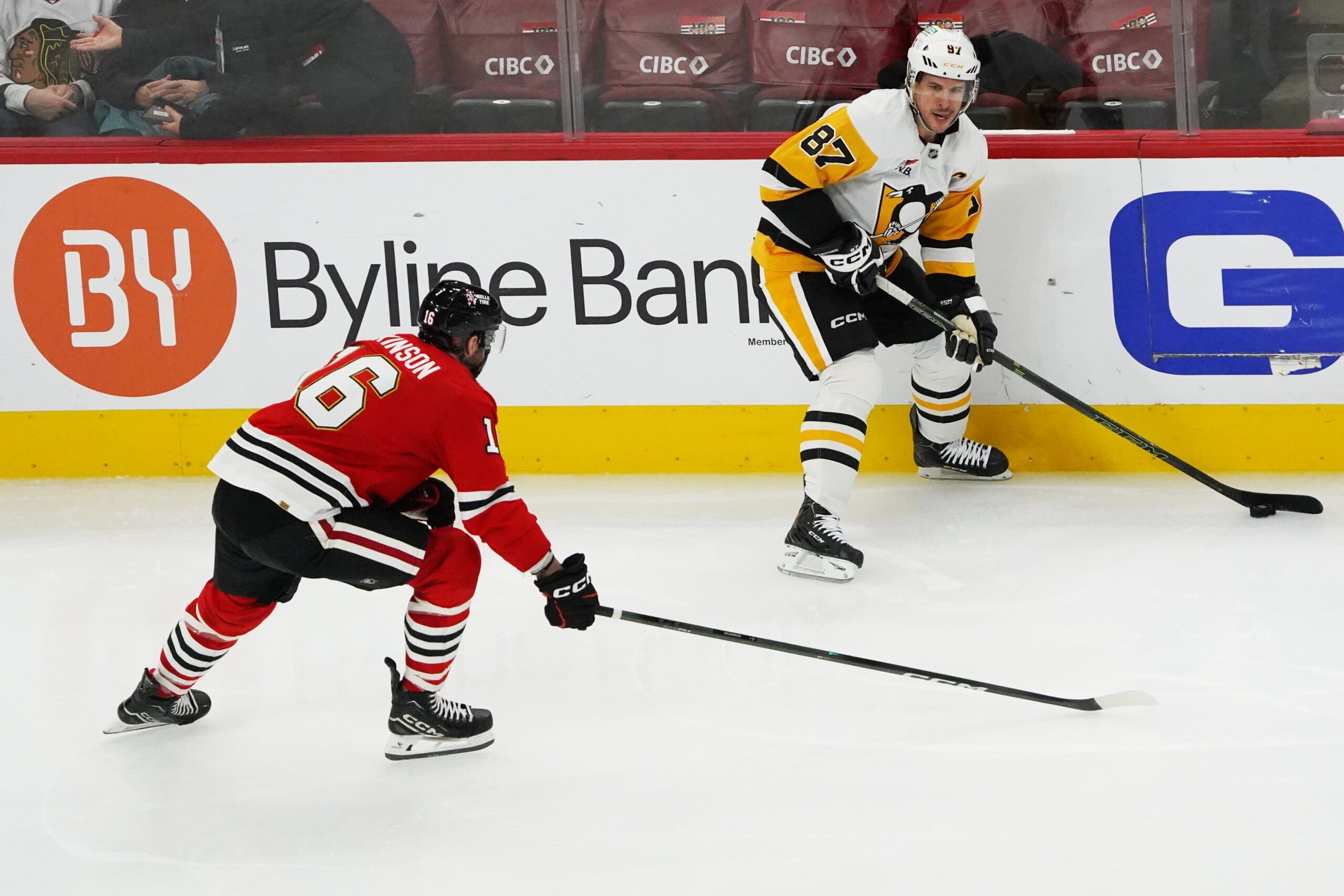 Dec 28, 2025; Chicago, Illinois, USA; Chicago Blackhawks center Jason Dickinson (16) defends Pittsburgh Penguins center Sidney Crosby (87) during the second period at United Center. Mandatory Credit: David Banks-Imagn Images
