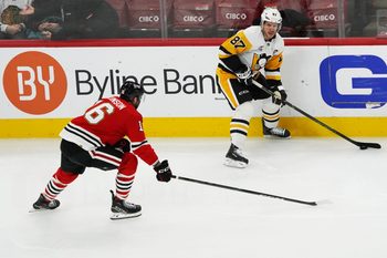 Dec 28, 2025; Chicago, Illinois, USA; Chicago Blackhawks center Jason Dickinson (16) defends Pittsburgh Penguins center Sidney Crosby (87) during the second period at United Center. Mandatory Credit: David Banks-Imagn Images