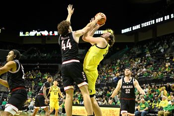 Dec 28, 2025; Eugene, Oregon, USA; Omaha Mavericks forward Brock Scholl (44) blocks a shot by Oregon Ducks center Nate Bittle (32) but is called for a foul during the first half at Matthew Knight Arena. Mandatory Credit: Craig Strobeck-Imagn Images