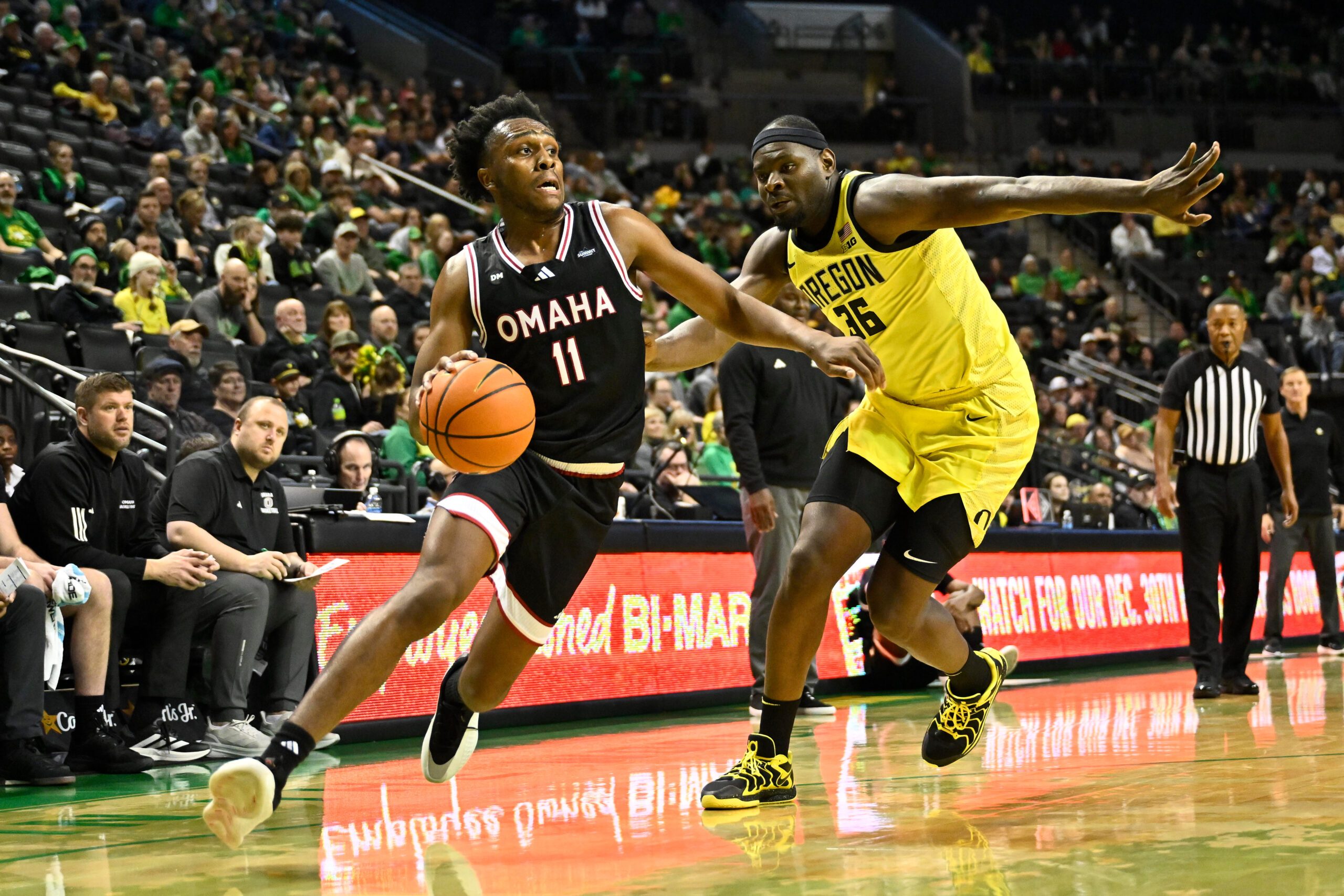 Dec 28, 2025; Eugene, Oregon, USA; Omaha Mavericks guard Paul Djobet (11) drives to the basket against Oregon Ducks center Ege Demir (36) during the second half at Matthew Knight Arena. Mandatory Credit: Craig Strobeck-Imagn Images