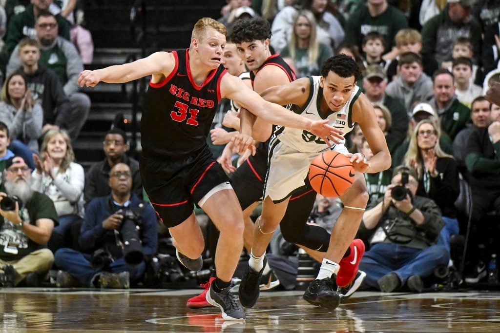 Michigan State's Divine Ugochukwu, right, is pressured by Cornell's Cooper Noard during the first half on Monday, Dec. 29, 2025, at the Breslin Center in East Lansing.