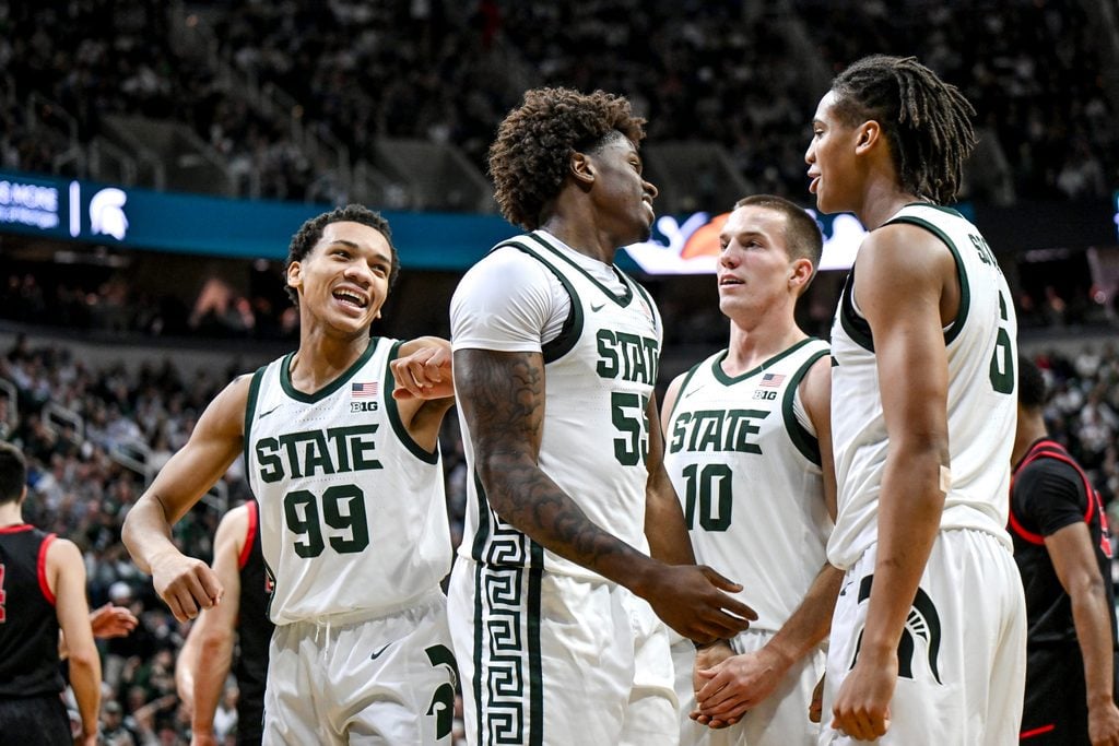 Michigan State's Coen Carr, center, celebrates his dunk with Divine Ugochukwu, left, Denham Wojcik and Jordan Scott, right, against Cornell during the second half on Monday, Dec. 29, 2025, at the Breslin Center in East Lansing.