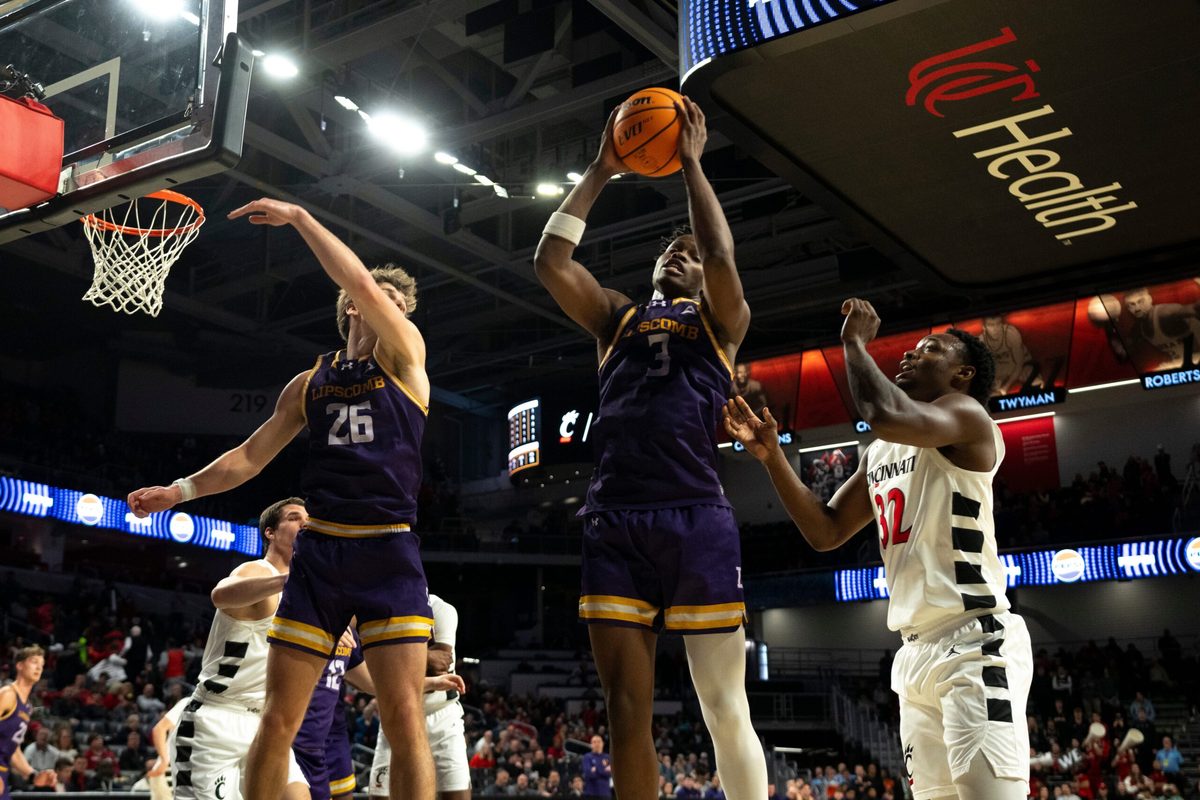 Lipscomb Bisons forward Kennedy Okpara (3) grabs a rebound over Cincinnati Bearcats guard Jalen Celestine (32) in the second half of the NCAA basketball game at Fifth Third Arena in Cincinnati on Dec. 29, 2025.