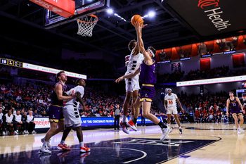 Dec 29, 2025; Cincinnati, Ohio, USA; Cincinnati Bearcats forward Baba Miller (18) blocks a shot by Lipscomb Bisons center Grant Asman (35) in the first half at Fifth Third Arena. Mandatory Credit: Katie Stratman-Imagn Images