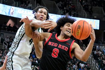 Dec 29, 2025; East Lansing, Michigan, USA;  Michigan State Spartans forward Kaleb Glenn (8) battles for a rebound with Cornell Big Red guard Adam Hinton (8) during the second half at Jack Breslin Student Events Center. Mandatory Credit: Dale Young-Imagn Images