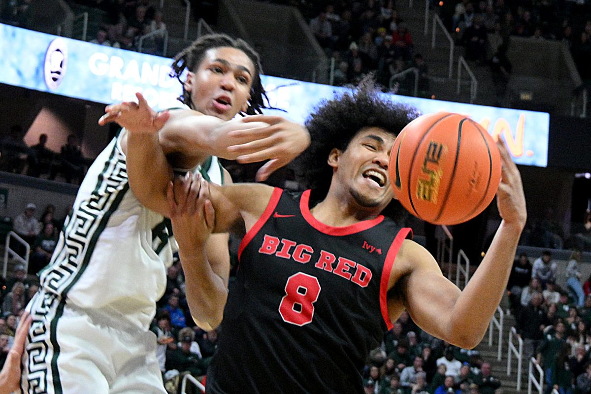 Dec 29, 2025; East Lansing, Michigan, USA; Michigan State Spartans forward Kaleb Glenn (8) battles for a rebound with Cornell Big Red guard Adam Hinton (8) during the second half at Jack Breslin Student Events Center. Mandatory Credit: Dale Young-Imagn Images