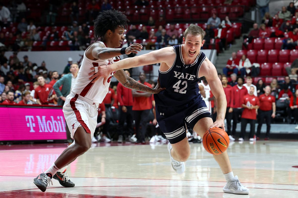 Dec 29, 2025; Tuscaloosa, Alabama, USA; Yale Bulldogs forward Nick Townsend (42) dribbles against Alabama Crimson Tide guard Aden Holloway (2) during the second half at Coleman Coliseum. Mandatory Credit: David Leong-Imagn Images