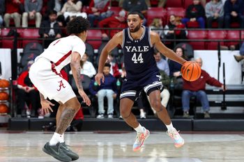 Dec 29, 2025; Tuscaloosa, Alabama, USA; Yale Bulldogs guard Devon Arlington (44) dribbles against Alabama Crimson Tide guard Jalil Bethea (1) during the second half at Coleman Coliseum. Mandatory Credit: David Leong-Imagn Images