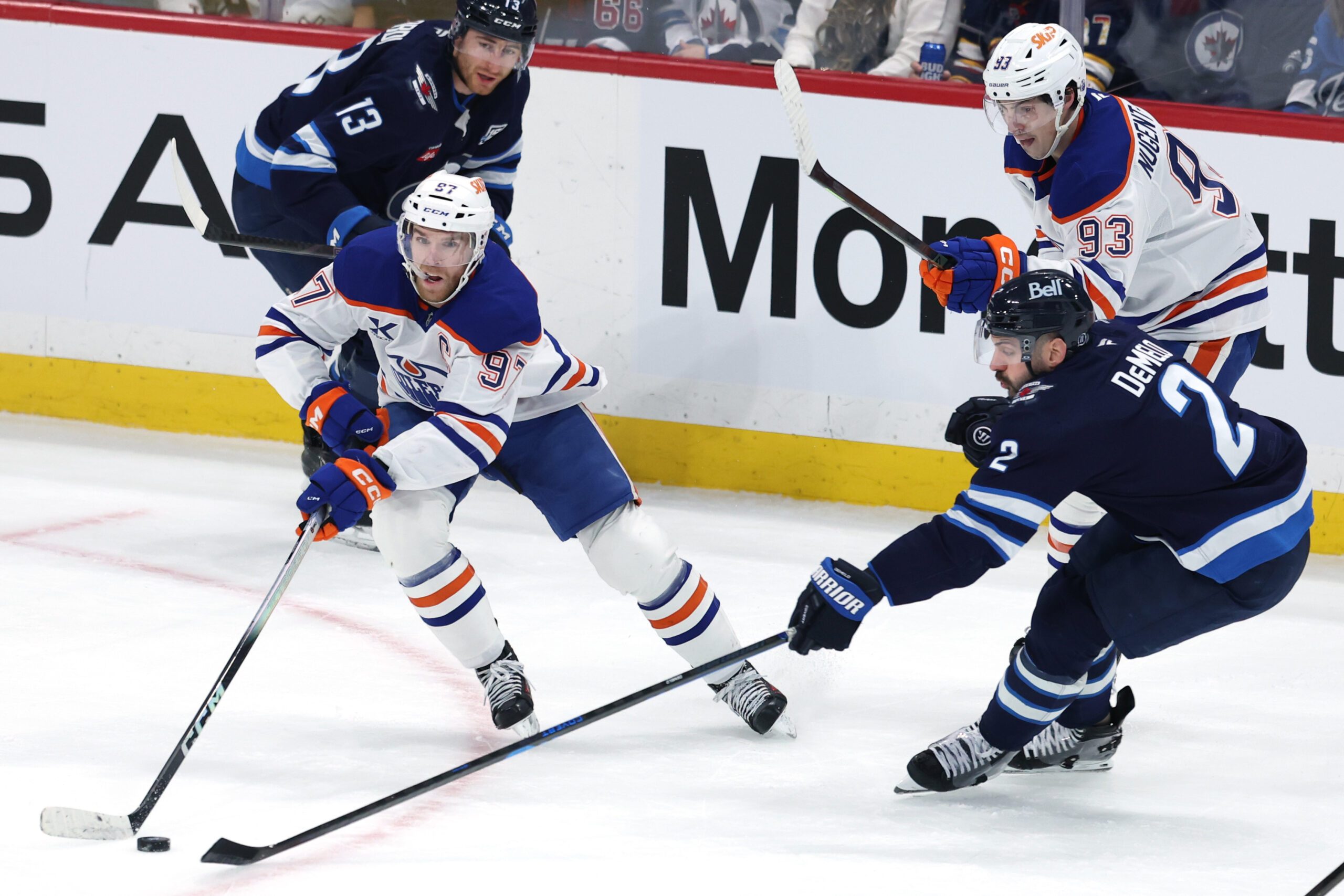 Dec 29, 2025; Winnipeg, Manitoba, CAN; Edmonton Oilers center Connor McDavid (97) is stick checked by Winnipeg Jets defenseman Dylan Demelo (2) in the third period at Canada Life Centre. Mandatory Credit: James Carey Lauder-Imagn Images