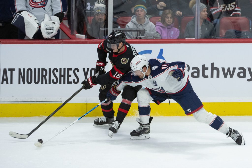 Dec 29, 2025; Ottawa, Ontario, CAN; Ottawa Senators center Tim Stutzle (18) battles with Columbus Blue Jackets left wing Miles Wood (11) for control of the puck in the third period at the Canadian Tire Centre. Mandatory Credit: Marc DesRosiers-IMAGN Images