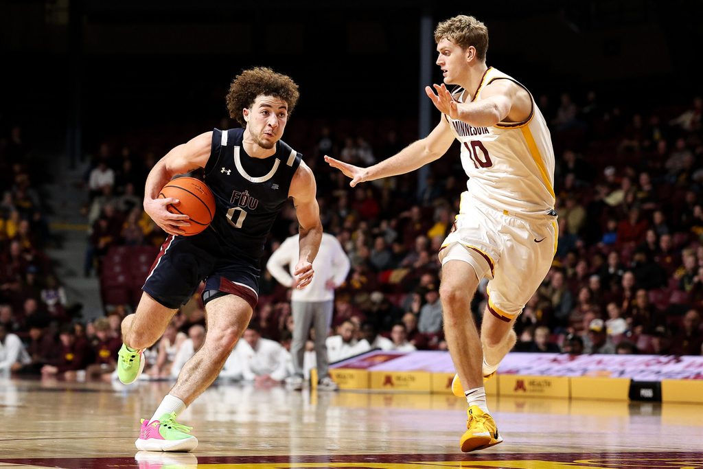 Dec 29, 2025; Minneapolis, Minnesota, USA; Fairleigh Dickinson Knights guard Joey Niesman (0) works around Minnesota Golden Gophers forward Cade Tyson (10) during the second half at Williams Arena. Mandatory Credit: Matt Krohn-Imagn Images