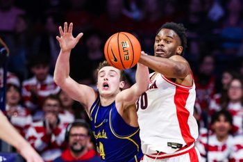 Dec 29, 2025; Tucson, Arizona, USA; South Dakota State Jackrabbits center Damon Wilkinson (34) and Arizona Wildcats forward Tobe Awaka (30) attempt to catch the ball during the second half of the game at McKale Memorial Center. Mandatory Credit: Aryanna Frank-Imagn Images
